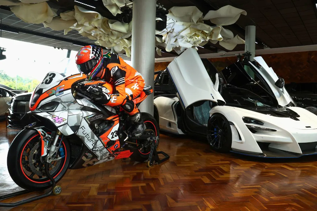 FuturExotics x AJ Venter x Isle Of Mann TT - AJ Bike dealership pose Maclaren