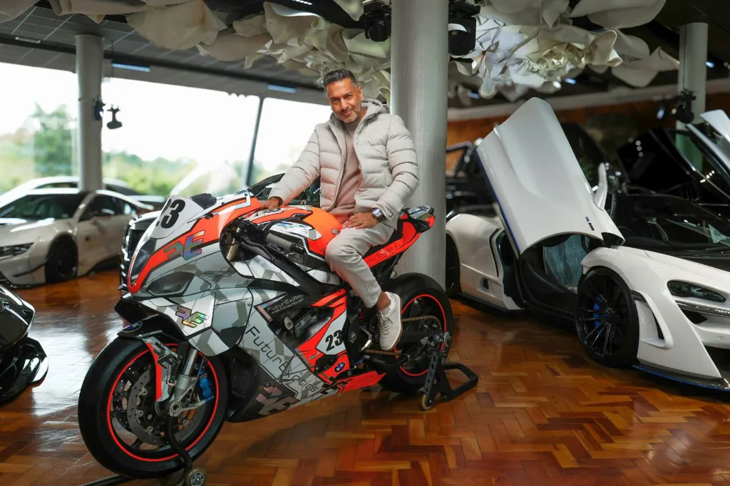 FuturExotics x AJ Venter x Isle Of Mann TT - Zunaid Moti pose on AJ Venter TT bike